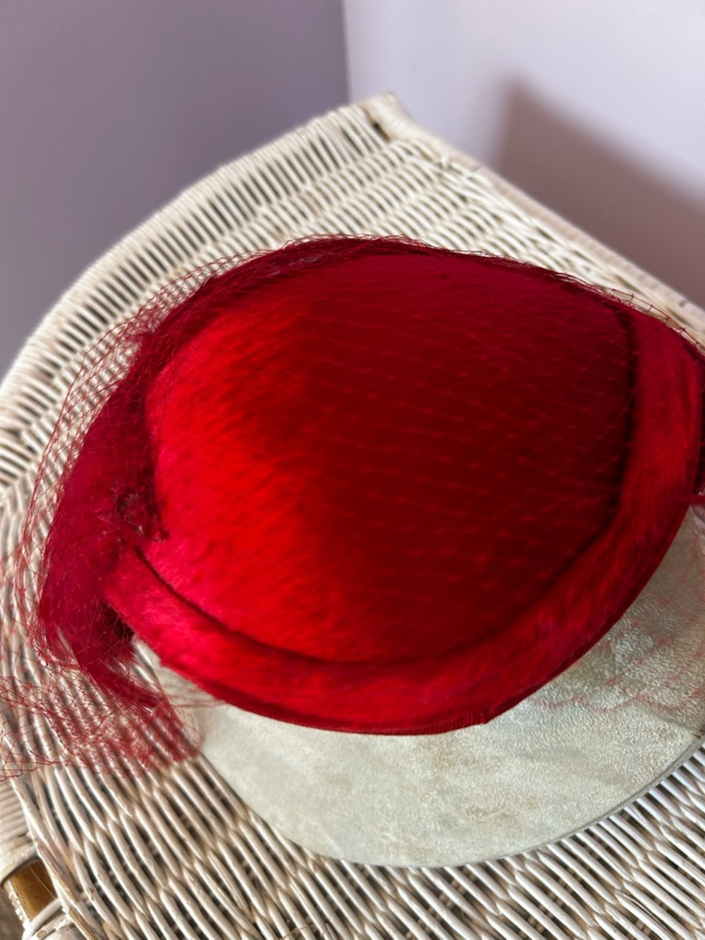 Red feathered woman’s fascinator hat